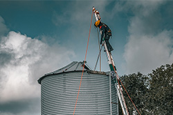 Rescue worker on ladder that is leaning against a silo