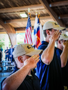 Cadets saluting the American and Texas Flags.