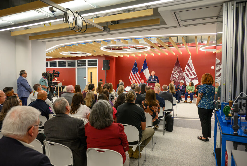 A person talking at a podium to an audiance