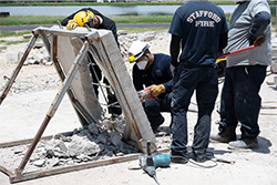 Workers using tools to break concrete