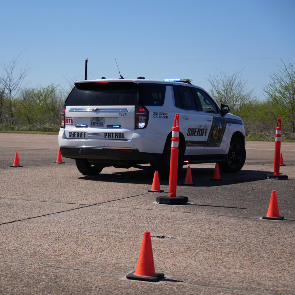 Picture of a police vehicle backing up on the emergency vehicle driving track during the Emergency Vehicle Operations Instructor course