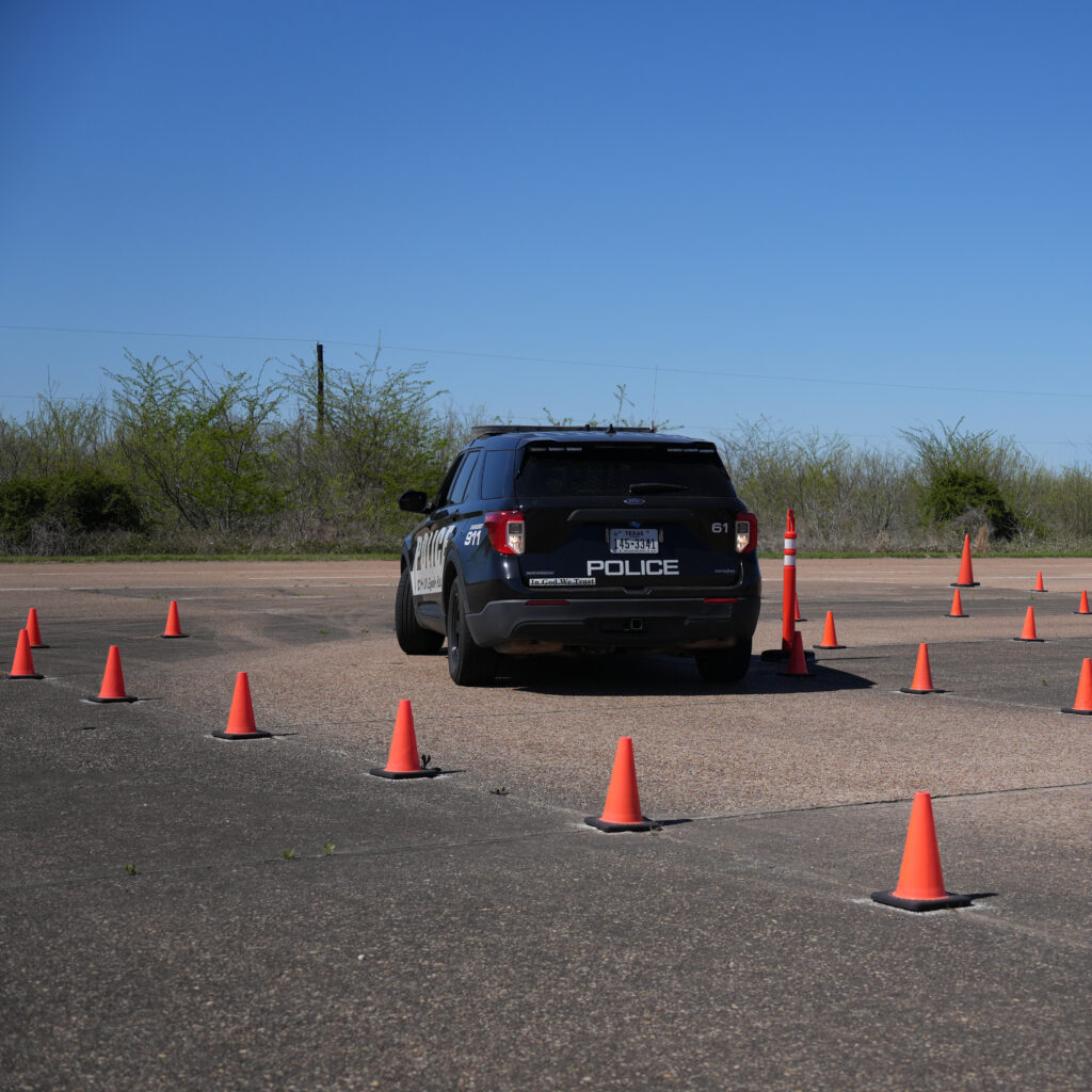 Picture of a police vehicle backing up on the emergency vehicle driving track during the Emergency Vehicle Operations Instructor course