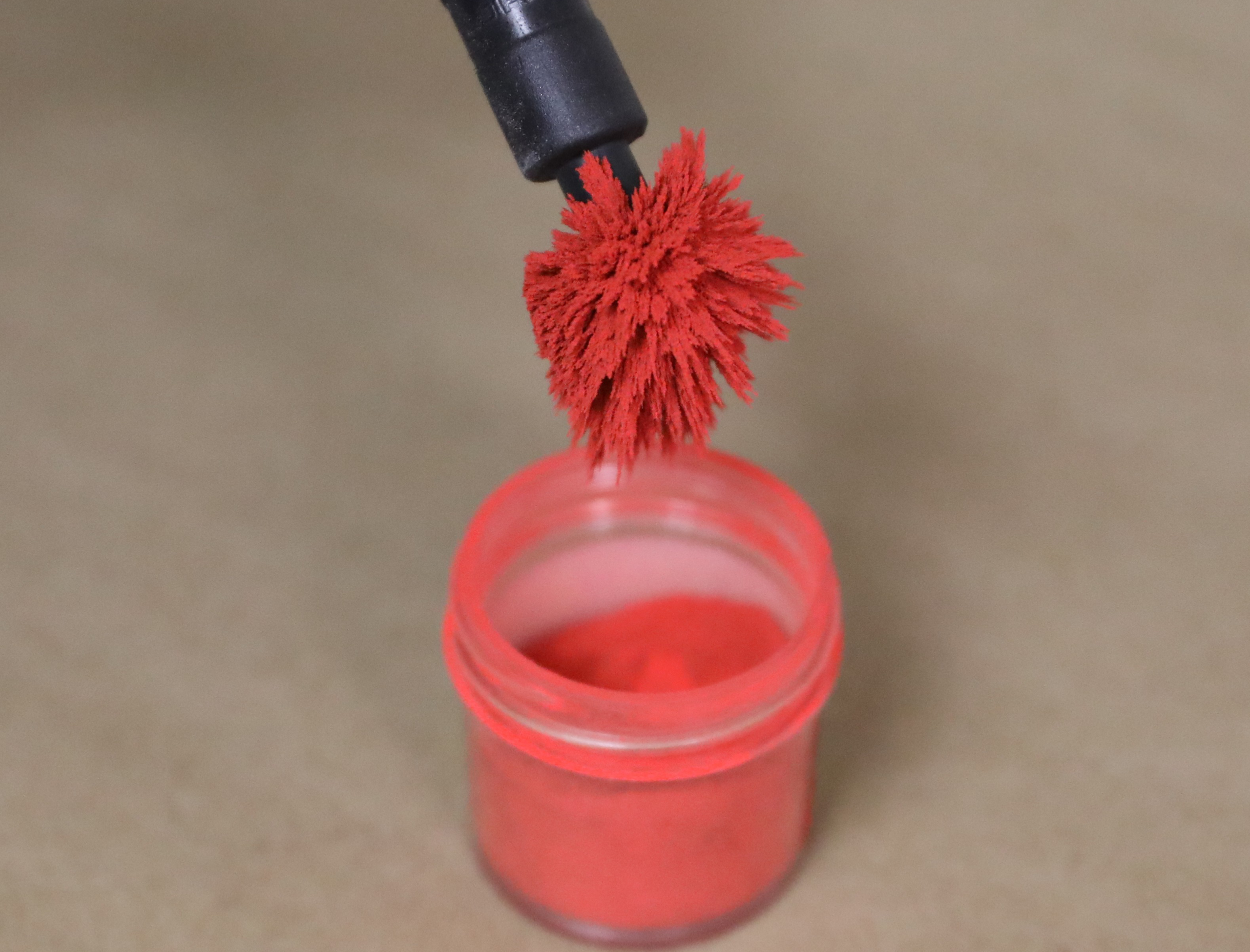 Brush containing red magnetic powder