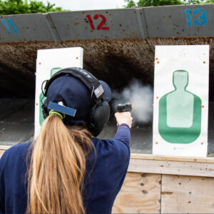 Female officer shooting handgun at firearms range
