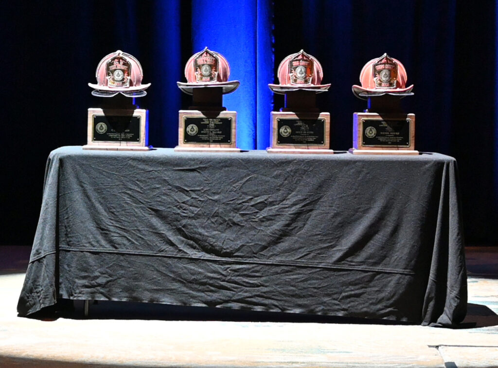 Four Helmet Trophies sitting on a table