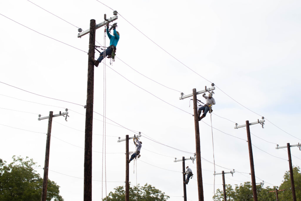 Lineworkers on linepoles 