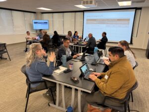 people sitting at a table talking to eachother