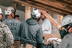 Rescuers stabilizing beams inside a building