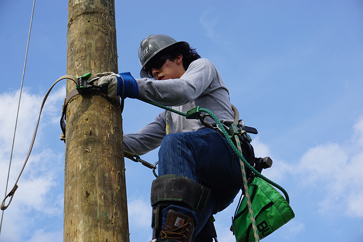 TEEX Lineworker Academy participant on a training utility pole