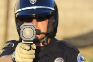 Picture of police officer holding a RADAR gun