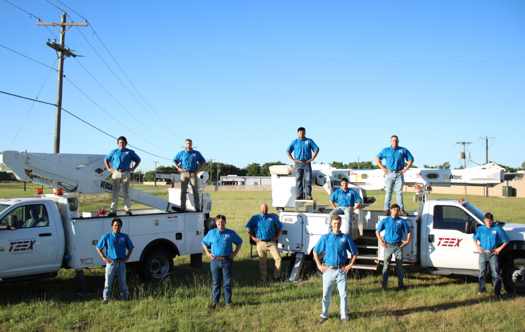 11 graduates of the TEEX Lineman Academy #5 gather at the RELLIS Campus.