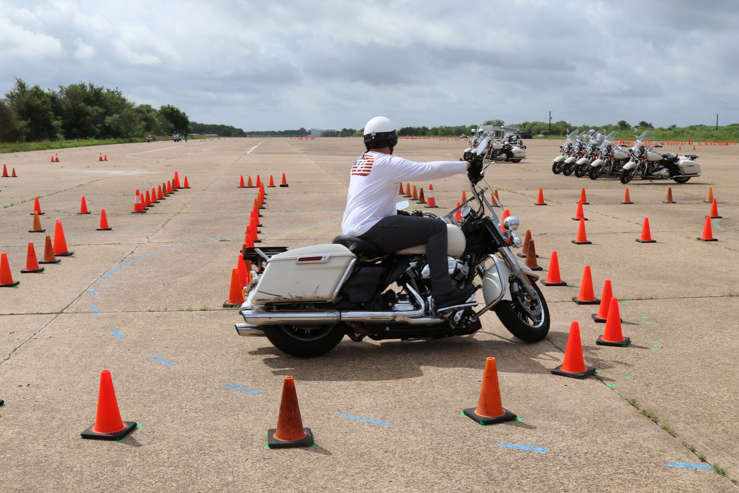 Male driving motorcycle through operator course