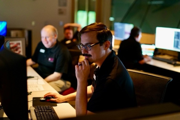 man sitting at computer