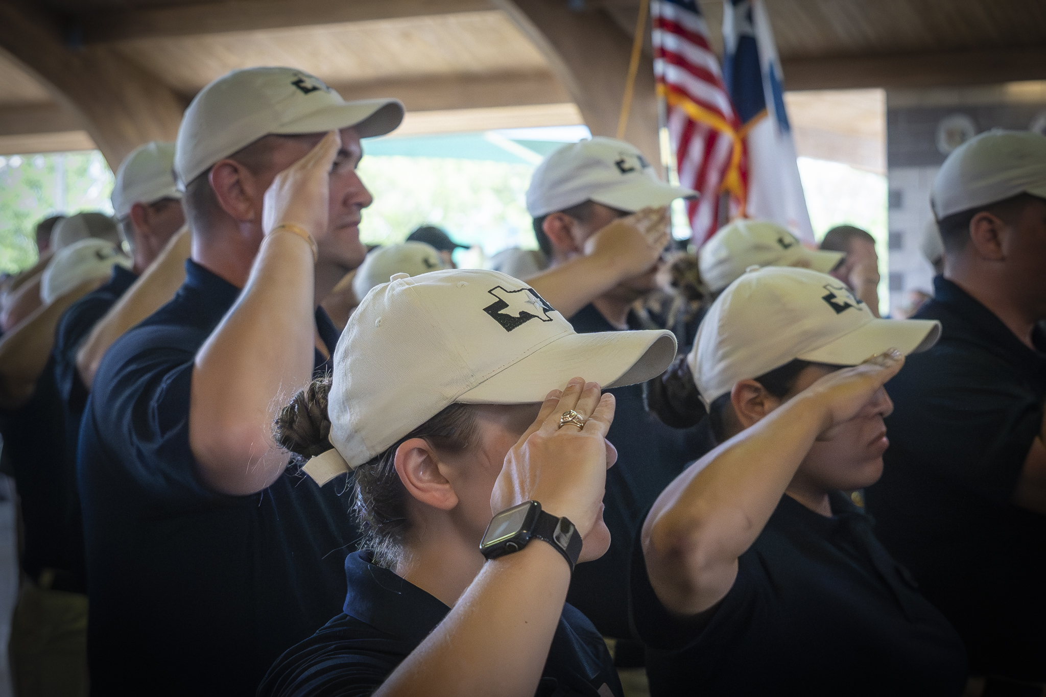 Cadets saluting the American and Texas Flags.