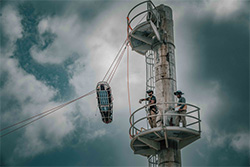 Tall prop with workers rescuing a person