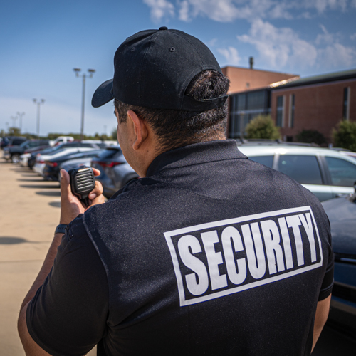 A security officer with a two way radio.