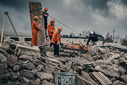 Rescuers searching rubble pile