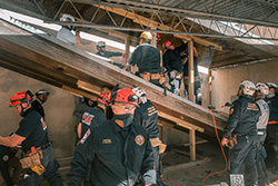 Rescuers inside a fallen movie theater