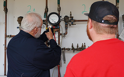 TEEX WWW BPAT instructor explaining a pressure gauge to a class participant.