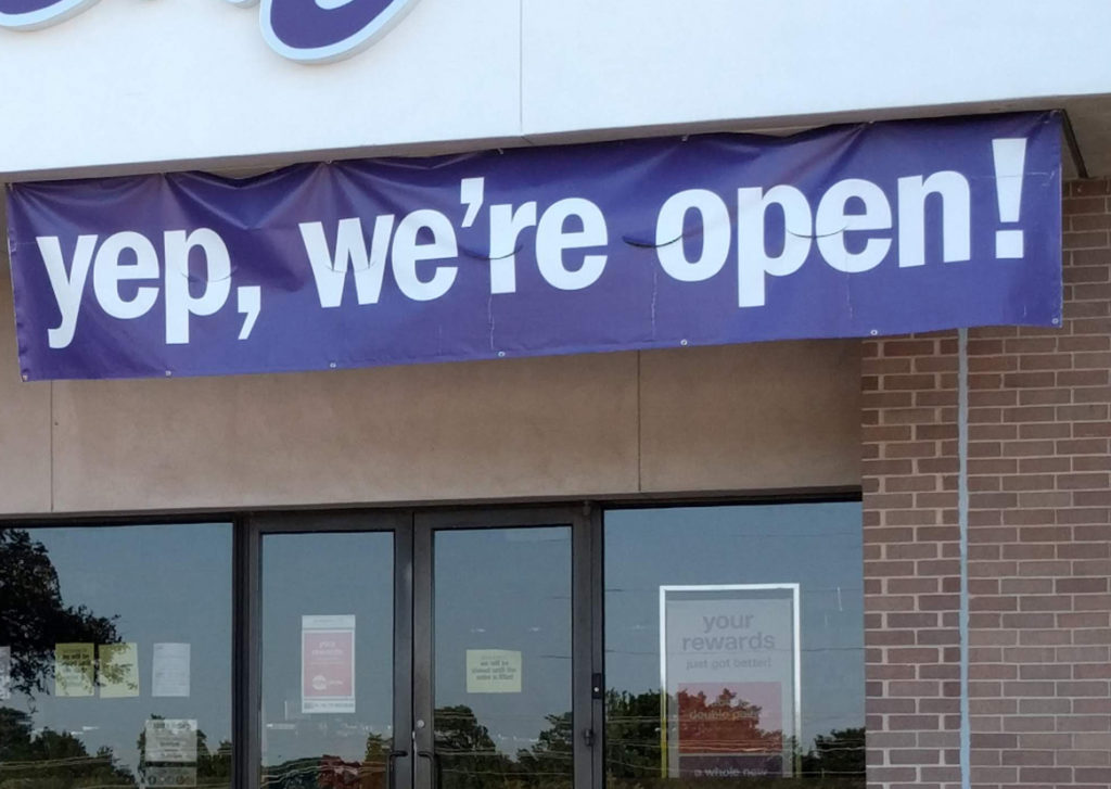 Building with 'Yep, We're Open' sign