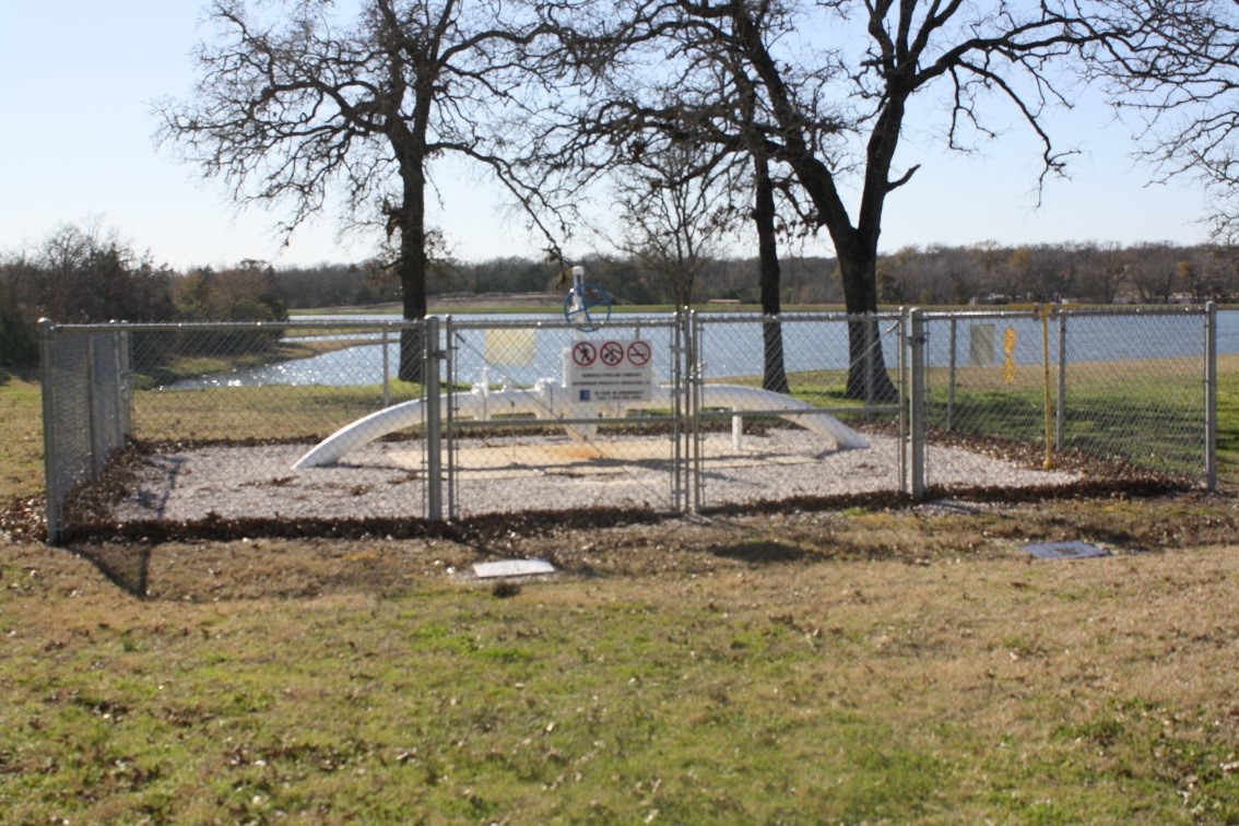 pipeline behind a gated chain link fence