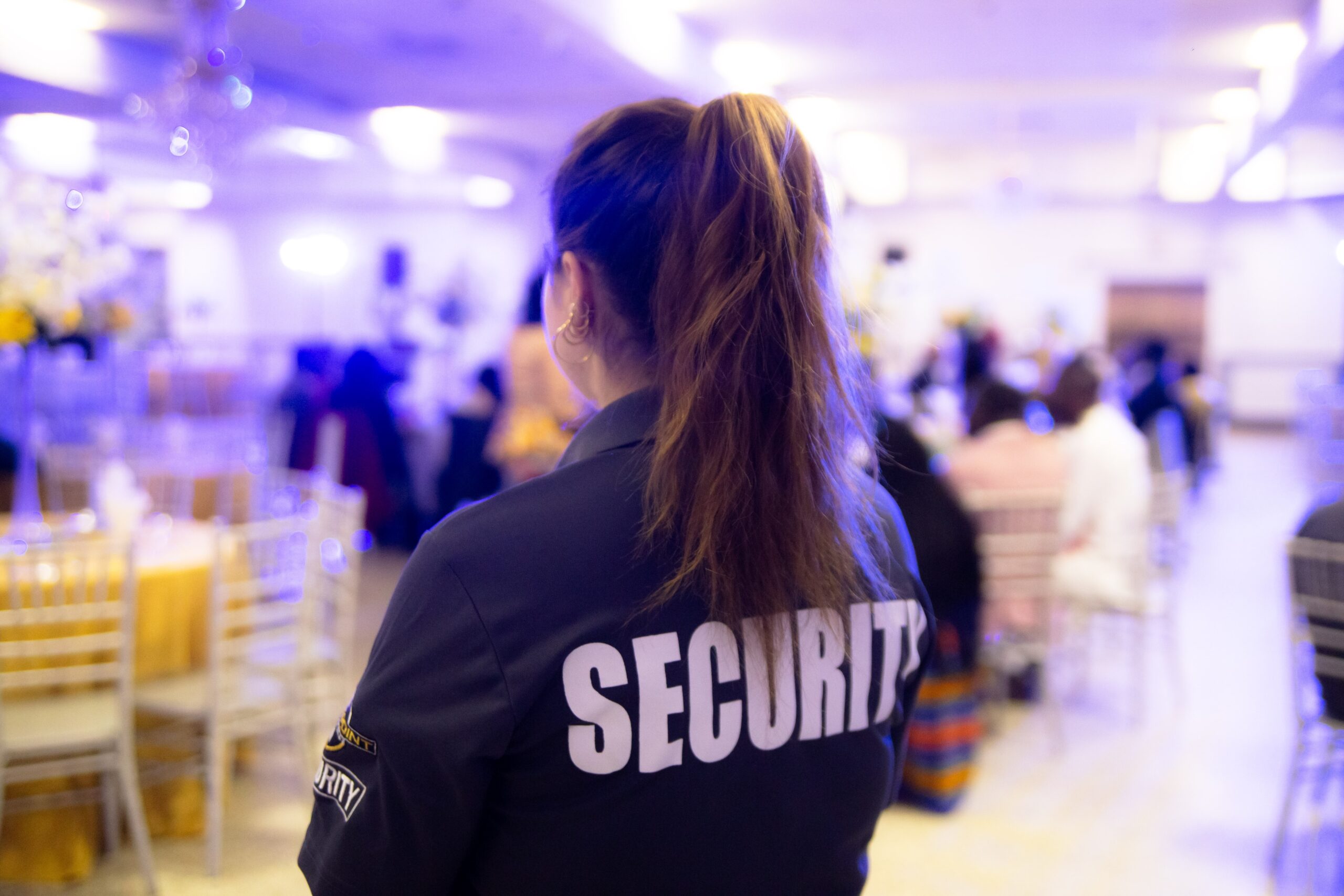 Female security guard patrolling an indoor event